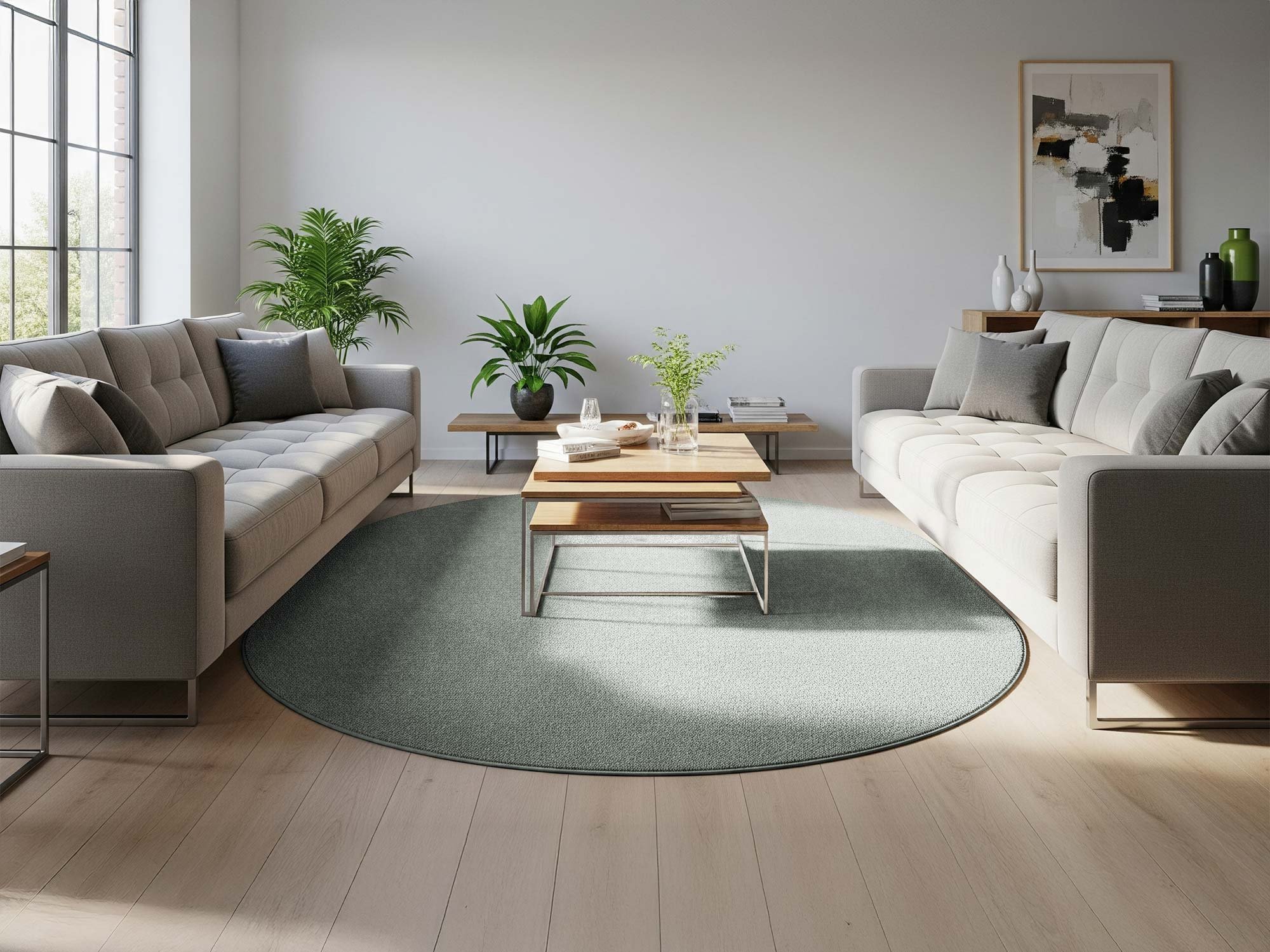 Der Linus Kurzflorteppich als Oval in Grün liegt in einem Wohnzimmer unter einem Sofa